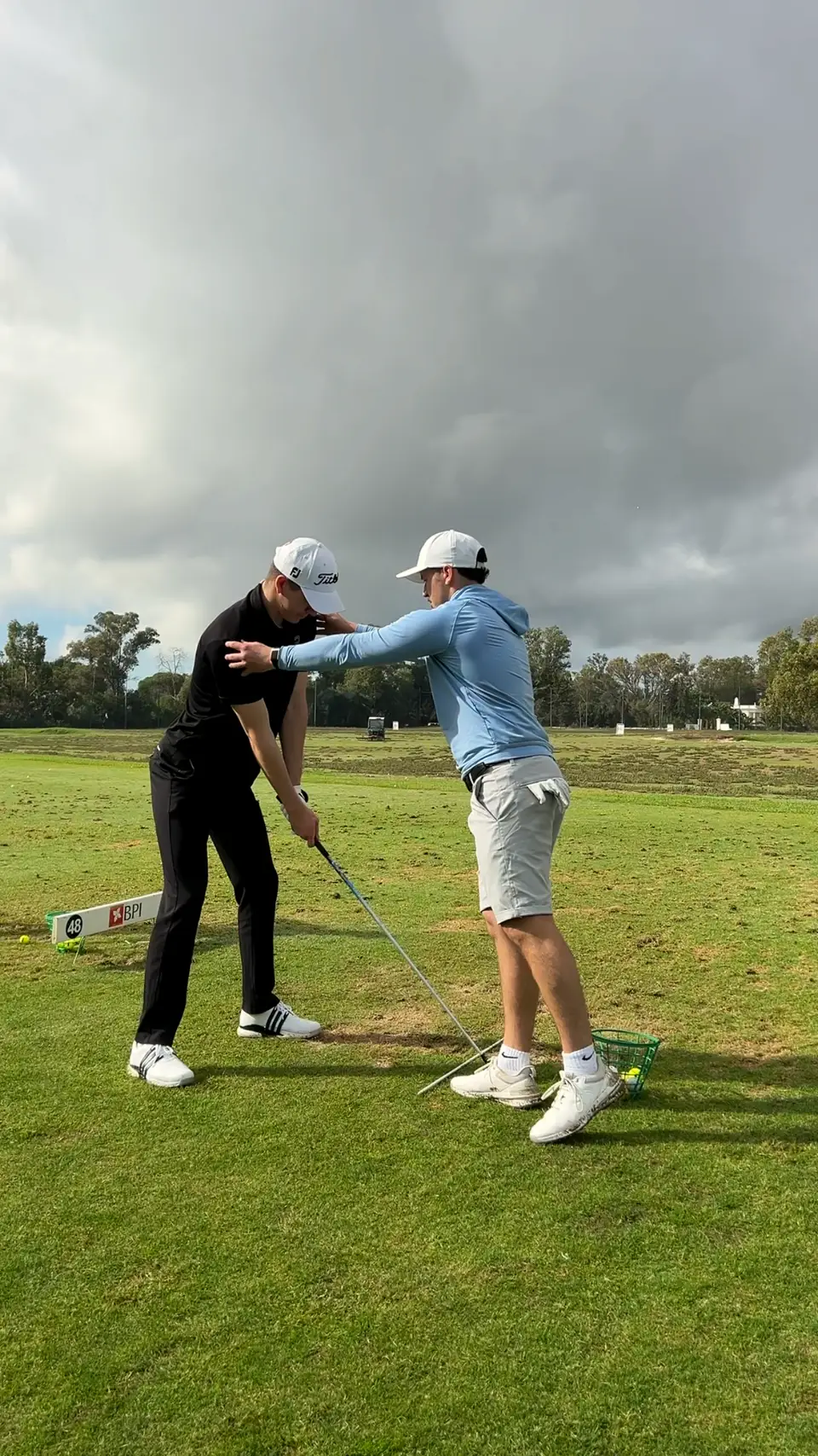 Huw hands-on, shaping a player's positions at the range