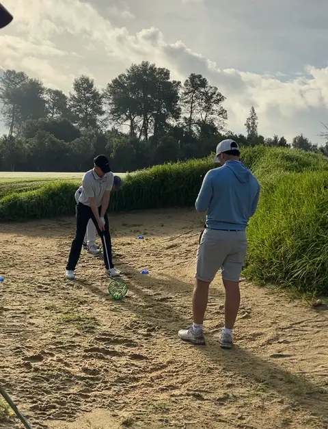 Huw watching a player hit from the practice area